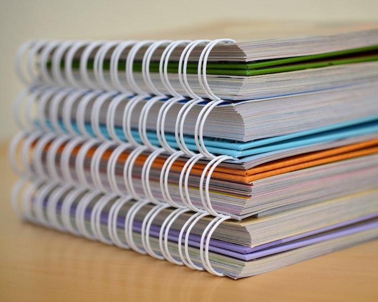 stacked spiral notebooks