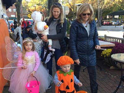 Two adults and three children in costumes during the library's Halloween Parade