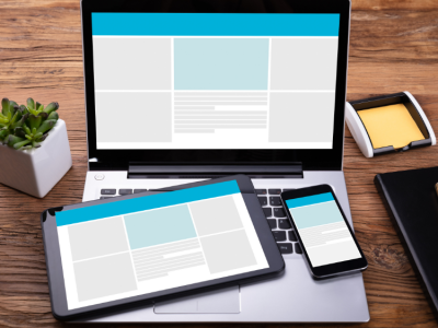 Image of a laptop, tablet and smart phone on a wooden table