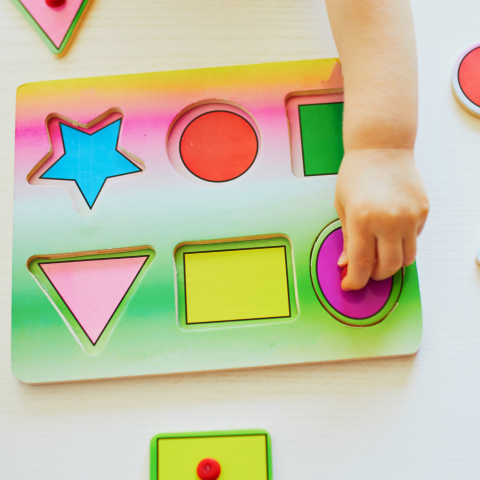Photograph of a child doing a simple puzzle