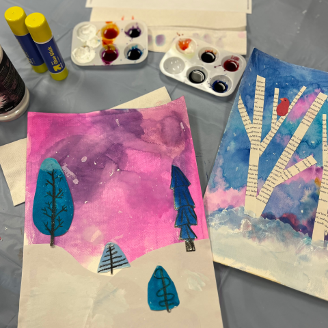Image of two artworks side-by-side on a gray tablecloth with art supplies