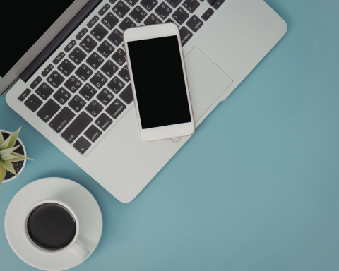 Photo of laptop and phone on blue background