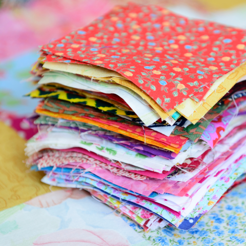 Stack of fabric squares on a quilt