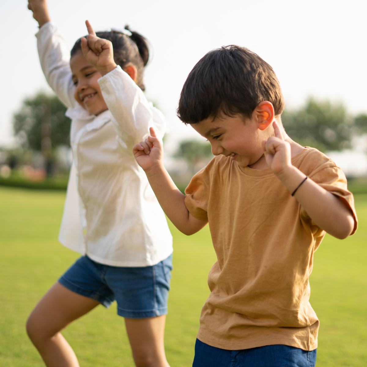 Photo of two kids dancing outside