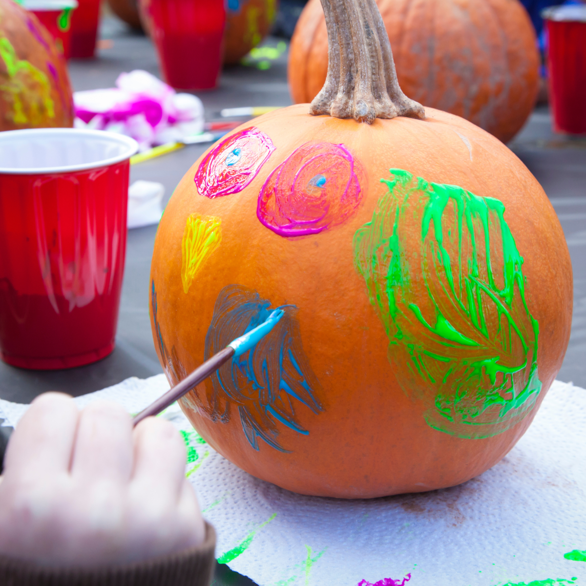 Image of a pumpkin being painted by a child