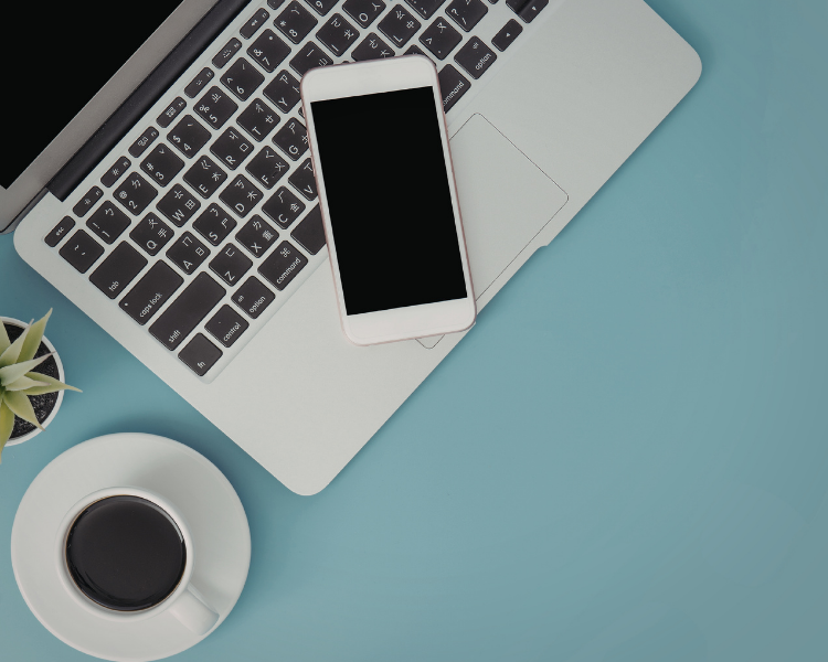 Photo of laptop and phone on blue background
