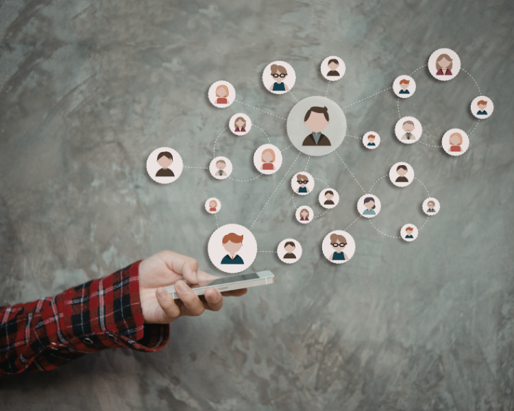 Image of hand holding a phone with icons of cartoon people