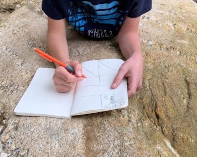 Kid writing in journal